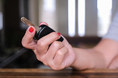 Close up Hand of a woman holding a car key.