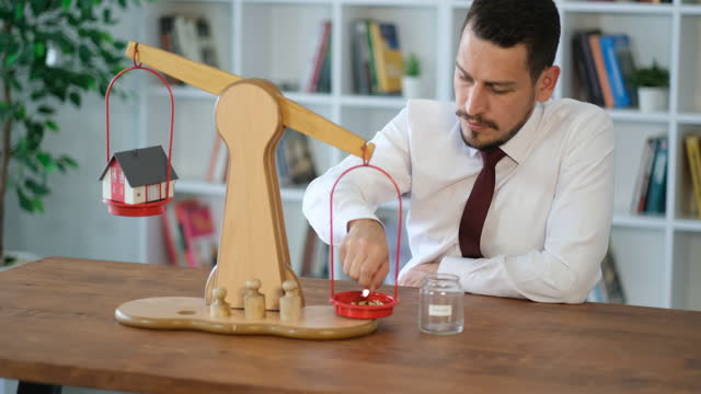 businessman working on budget balance on equal-arm scales