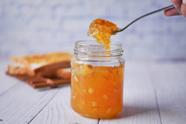 istock orange fruit jelly in a jar on table 1501022854