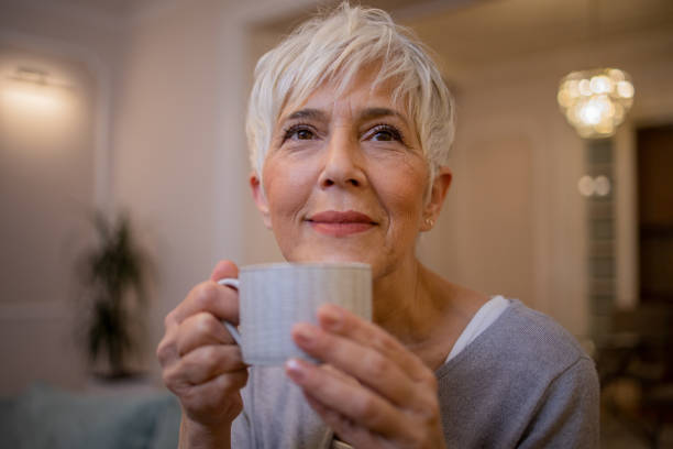 istock Woman having coffee and relaxing at home 1501023319