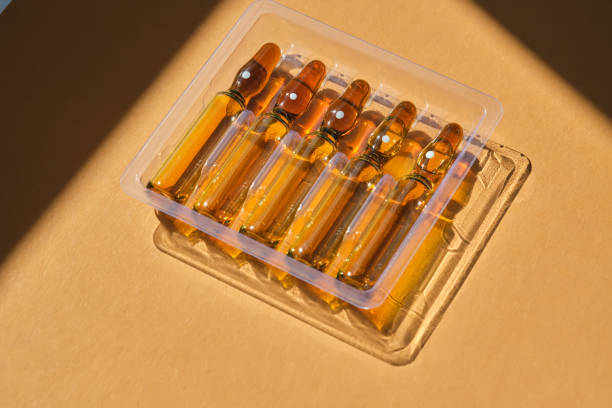 istock Glass ampoules on a beige orange background. 1501028514