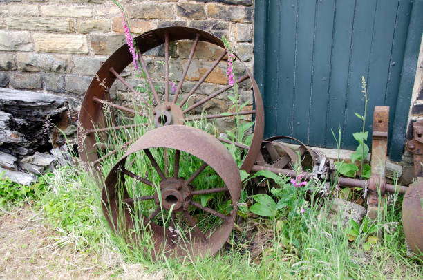 istock Rusted metal wheels next to stone wall 1501029561
