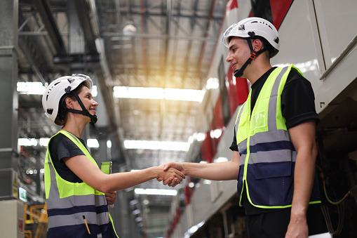 A couple of rail engineers shook hands to celebrate after examining the quality of the power train system.