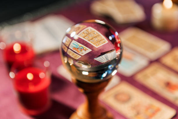 Crystal ball on wooden stand. White background. Horizontal.