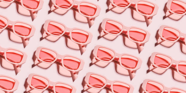 istock Minimal pattern from pink eyeglasses on rose background, visual trends summer concept. Top view aesthetic photo, colored sunglasses as creative geometric pattern, monochrome flat lay glasses 1501044822