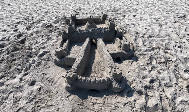 istock Sand castle on the beach. Summer time. Hand made construction 1501045640
