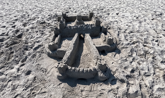 Sand castle on the beach. Summer time. Hand made construction