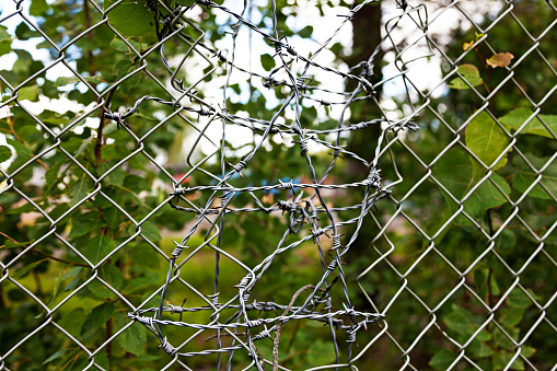 broken fence mended with barbed wire