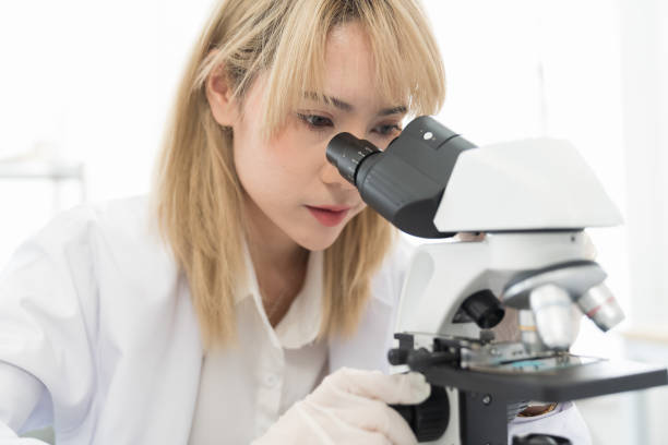 istock Asian woman scientist looking through microscope doing analysis and test sample in the laboratory 1501047182