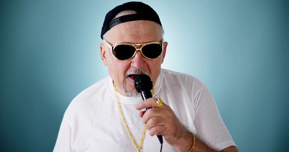 Music Party Star In Sunglasses With Microphone. Man On Stage