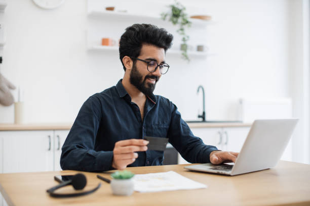 istock Businessman using credit card and laptop at work from home 1501055229