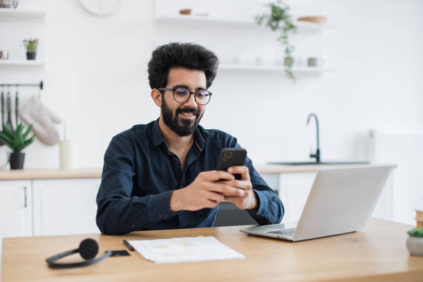 istock Male texting message on phone in kitchen during working hour 1501055234