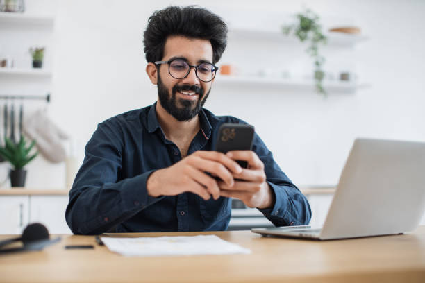 istock Male texting message on phone in kitchen during working hour 1501055238