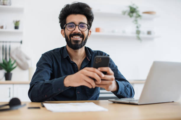 istock Male texting message on phone in kitchen during working hour 1501055240