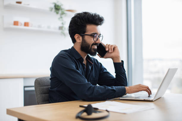 istock Business person chatting on mobile during work on laptop 1501055266
