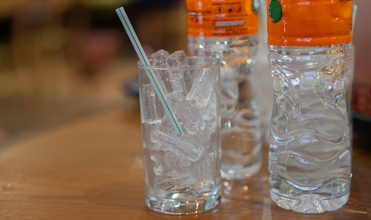 Glasses of different refreshing soda water with ice cubes isolated on white