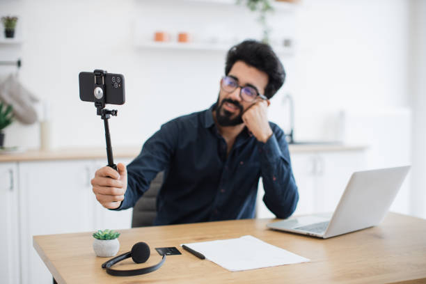 istock Cell phone on tripod used for online report of remote work 1501059725