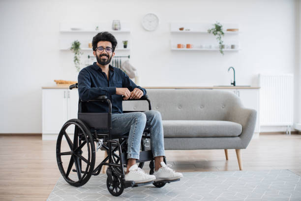 istock Wheelchair user spending pastime at home on sunny day 1501059742