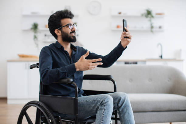 istock Person with disability chatting via video call at home 1501059776