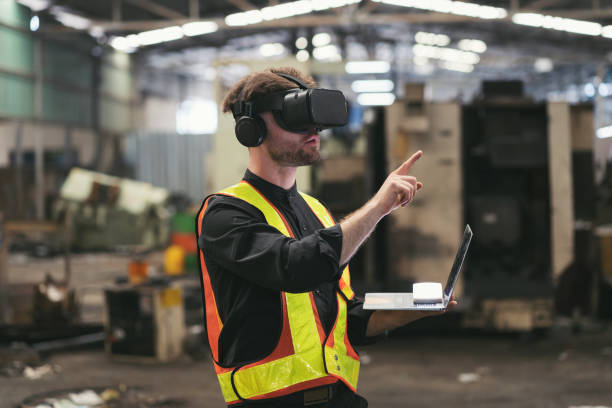 istock Male factory mechanic using virtual reality headset. Male engineer working or using virtual reality headset for checking machinery in industry factory and wearing safety uniform and helmet 1501060270