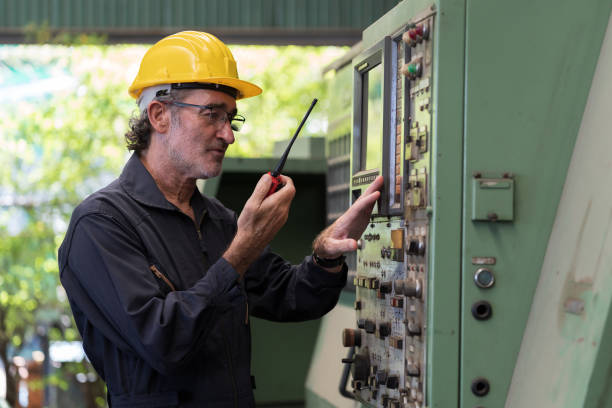 istock Senior male engineer worker working with digital tablet for control machine in factory. Mature male worker working with CNC machine with safety uniform, helmet in industry factory 1501060331