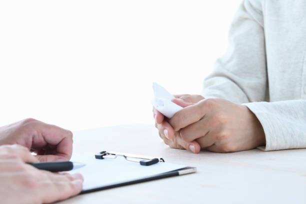 Interviewing between doctor and woman with handkerchief