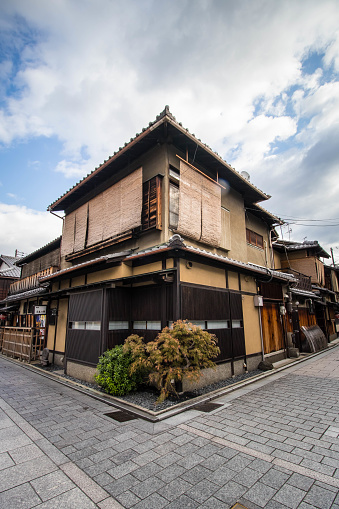 Kyoto, Japan - November 16, 2017: Japanese building on the curb in the Gion area. Gion is a district of Higashiyama-ku, Kyoto, Japan, originating as an entertainment district in the Sengoku period, in front of Yasaka Shrine.