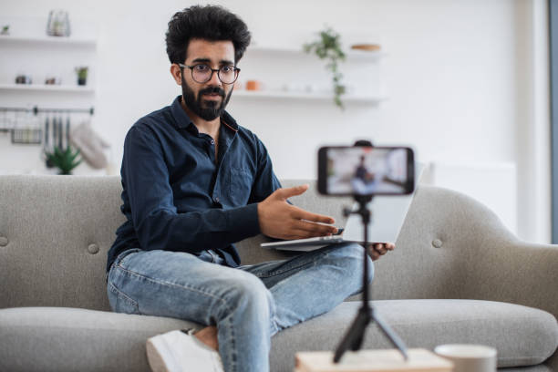 istock Arabian man using laptop and smartphone for making video 1501063330