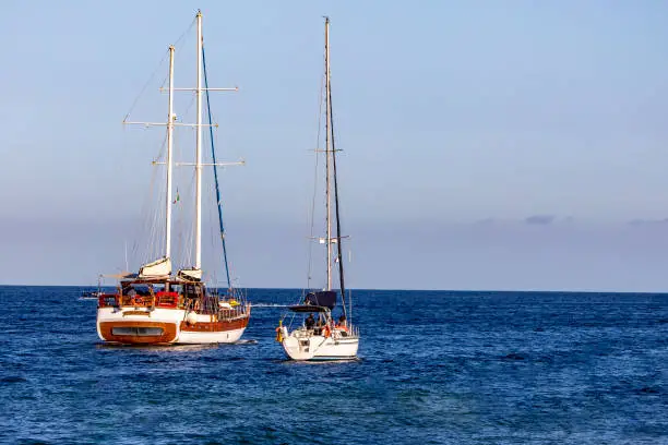 Photo of Sailboats navigating in the Sea of Cortez and the Pacific Ocean off the coast of Cabo San Lucas in the state of Baja California Sur, Mexico.