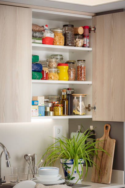 istock Open cabinet full of groceries in a modern kitchen 1501066649