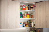 Kitchen cabinet full of groceries. Copy space