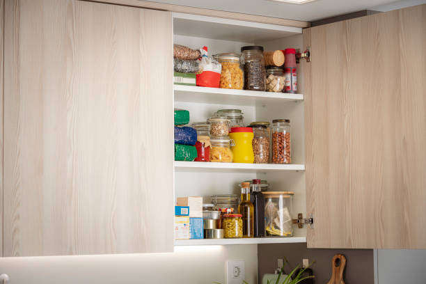Kitchen cabinet full of groceries. Copy space Open cabinet full of groceries in a modern kitchen cabinet stock pictures, royalty-free photos & images