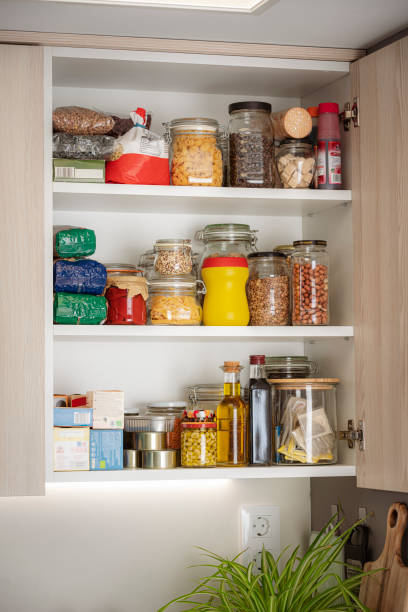 istock Open kitchen cabinet full of groceries 1501066677