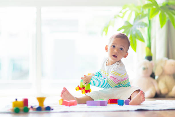 istock Baby boy playing with toy 1501067216