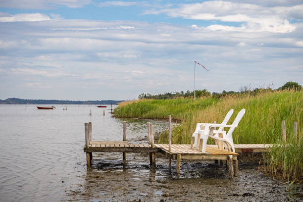 Plastic furniture on a small jetty with a view over the water at Kulhuse, a small city north west of Copenhagen