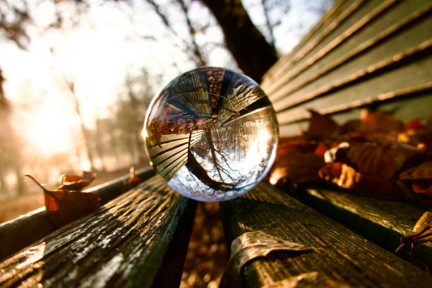 Crystal ball on wooden bench during sunrise