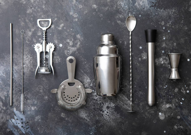 istock Various bar cocktail stainless steel utensils set on black stone background. 1501077331