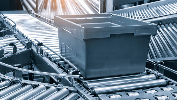 istock Crossing of the roller conveyor with plastic boxes, Production line conveyor roller transportation objects 1501079637