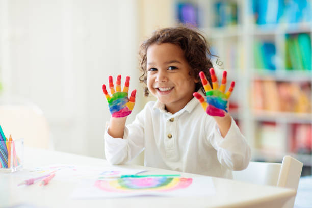 istock Child drawing rainbow. Paint on hands. 1501081861