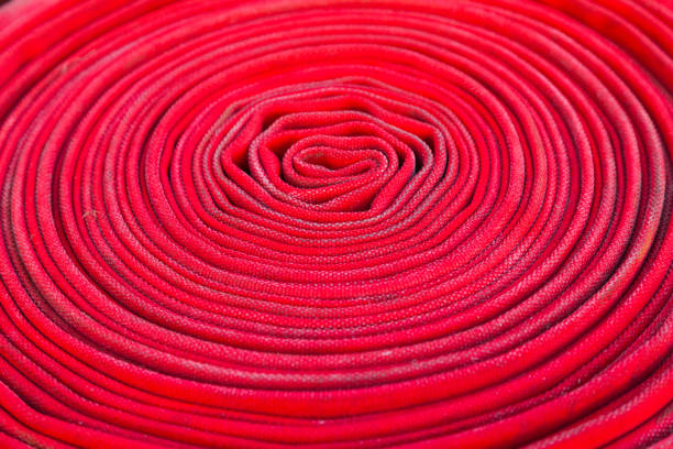 istock Twisted fire hose red color close up. 1501086623