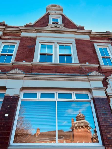 istock Low angle view of building with reflections in the window 1501090121