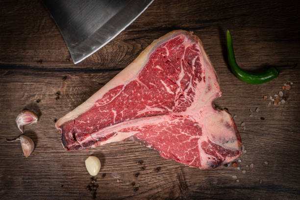 istock Raw beef steak with spices on a dark slate, stone or concrete background. Top view with copy space. 1501090660