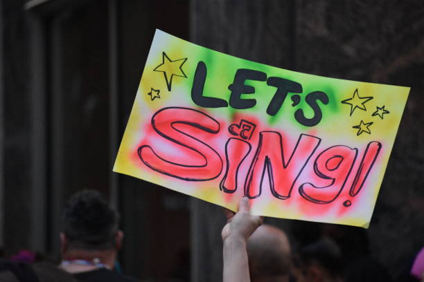 istock Audience holding handwritten sign that reads 