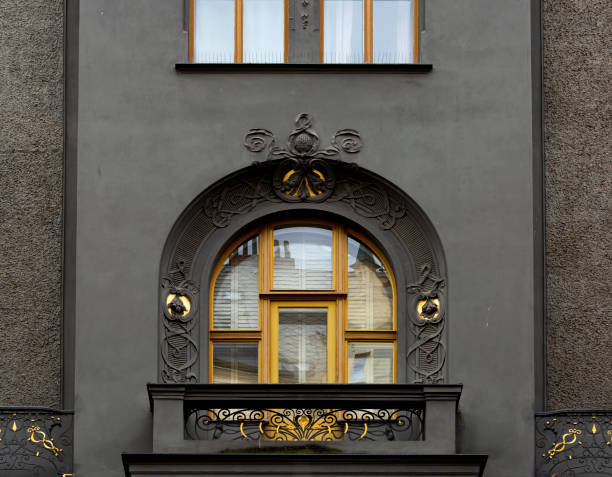 Shot in color detail on the facade of this historic building representing some character, animal or flower.
