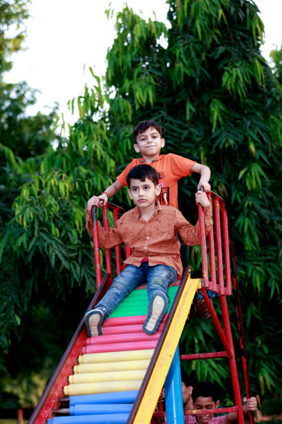 istock Children having fun on slide in the park 1501100974
