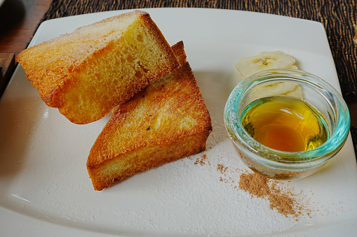 Room service is bringing breakfast with orange juice, croissant and french press coffee.