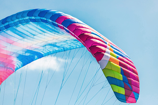 Colorful paraglider close-up against the blue sky. High quality photo