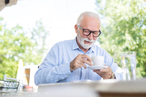 istock Smiling mature man Drinking coffee outdoors 1501107401