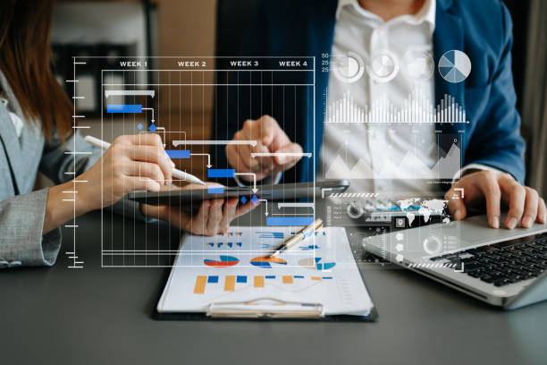 istock Businessman hand Project manager working and update tasks and Gantt chart scheduling virtual diagram.with smart phone, tablet and laptop in office. 1501111019