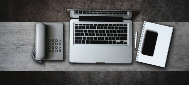office stuff with tablet, laptop ,smartphone, tablet and coffee cup notepad and documents top view shot.